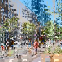 People walking down a street in the UK that has been revamped for pedestrians and cyclists